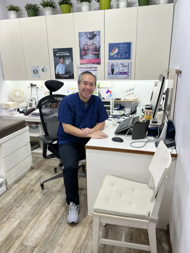 About Our Staff Dr Gideon Hong, Family Physician at GreenLink Medical Clinic, seated in his consultation room in Khatib, Yishun.